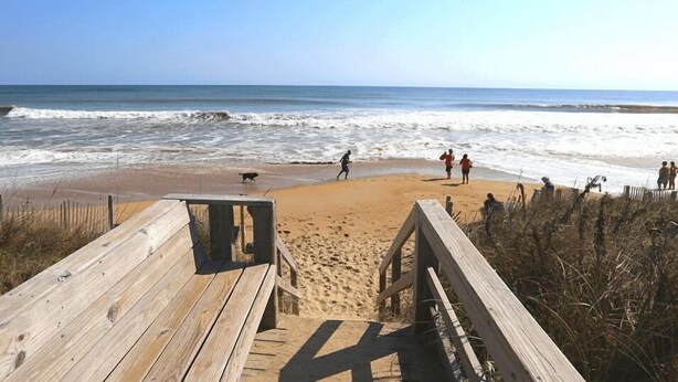 A wooden boardwalk leading to a sandy beach with waves in the background. - YES ABSOLUTELY - Family Friendly 4BR Oceanside home in Duck w/Private Pool & Hot Tub (Duck)