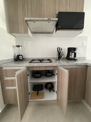 Enjoy cooking and dining in this well-organized kitchen with a stove, coffee maker, and blender.