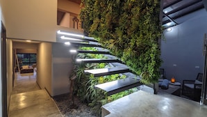 A staircase with integrated greenery, a modern design, and a view of the interior space.