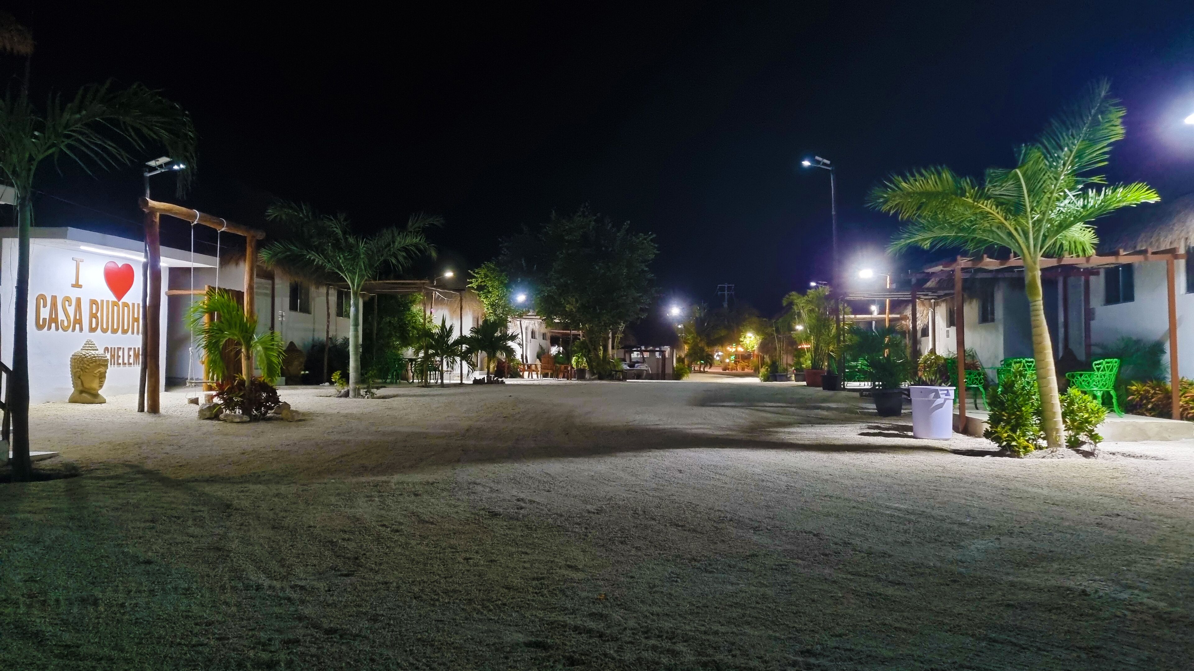 A nighttime view of a resort with a sign reading "I love Casa Budha."