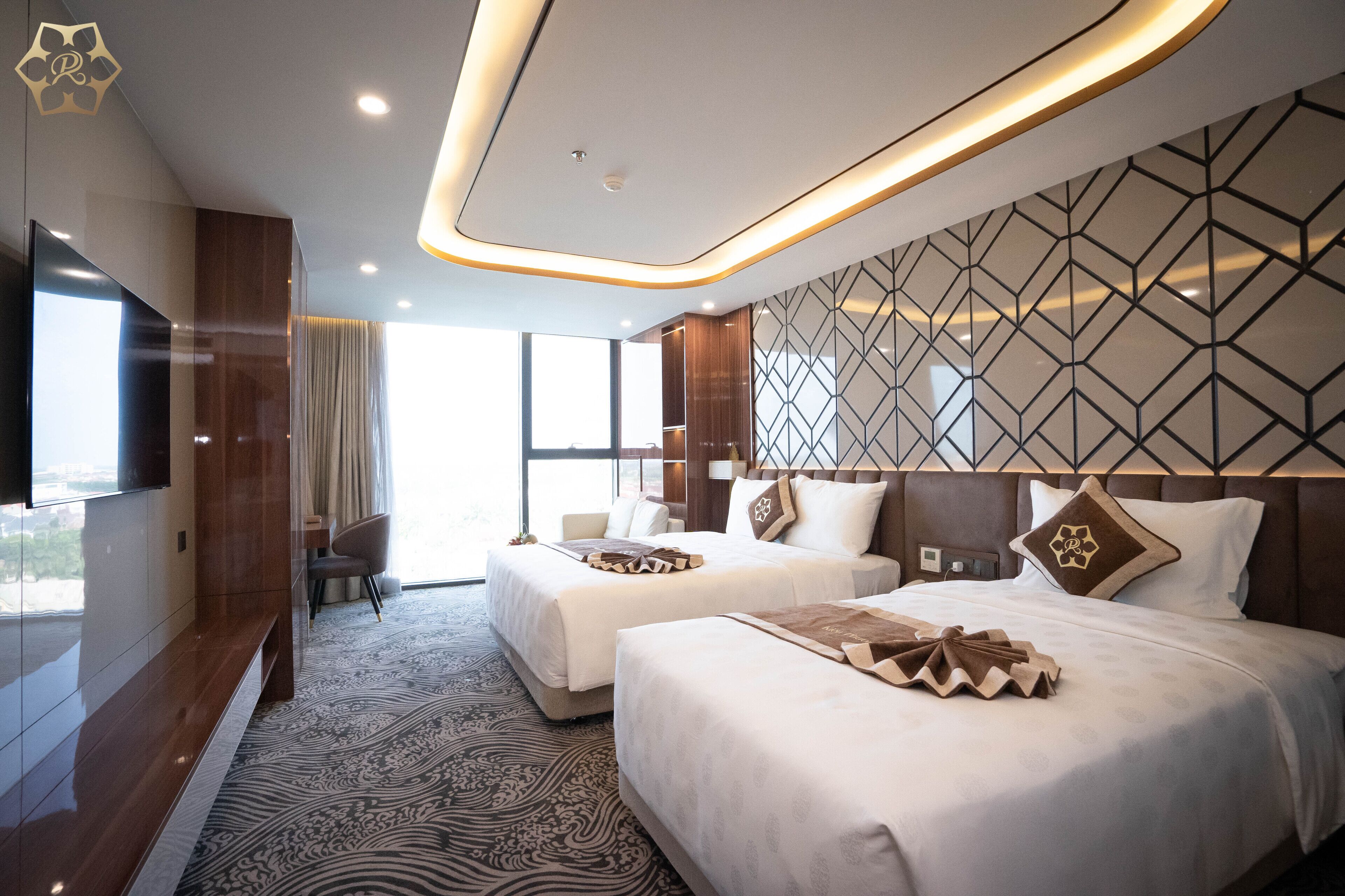 A hotel room with two beds, a large window, and a modern design.