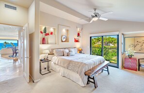 Un'ampia camera da letto con un letto grande, una panca, una scrivania e vista sull'esterno.