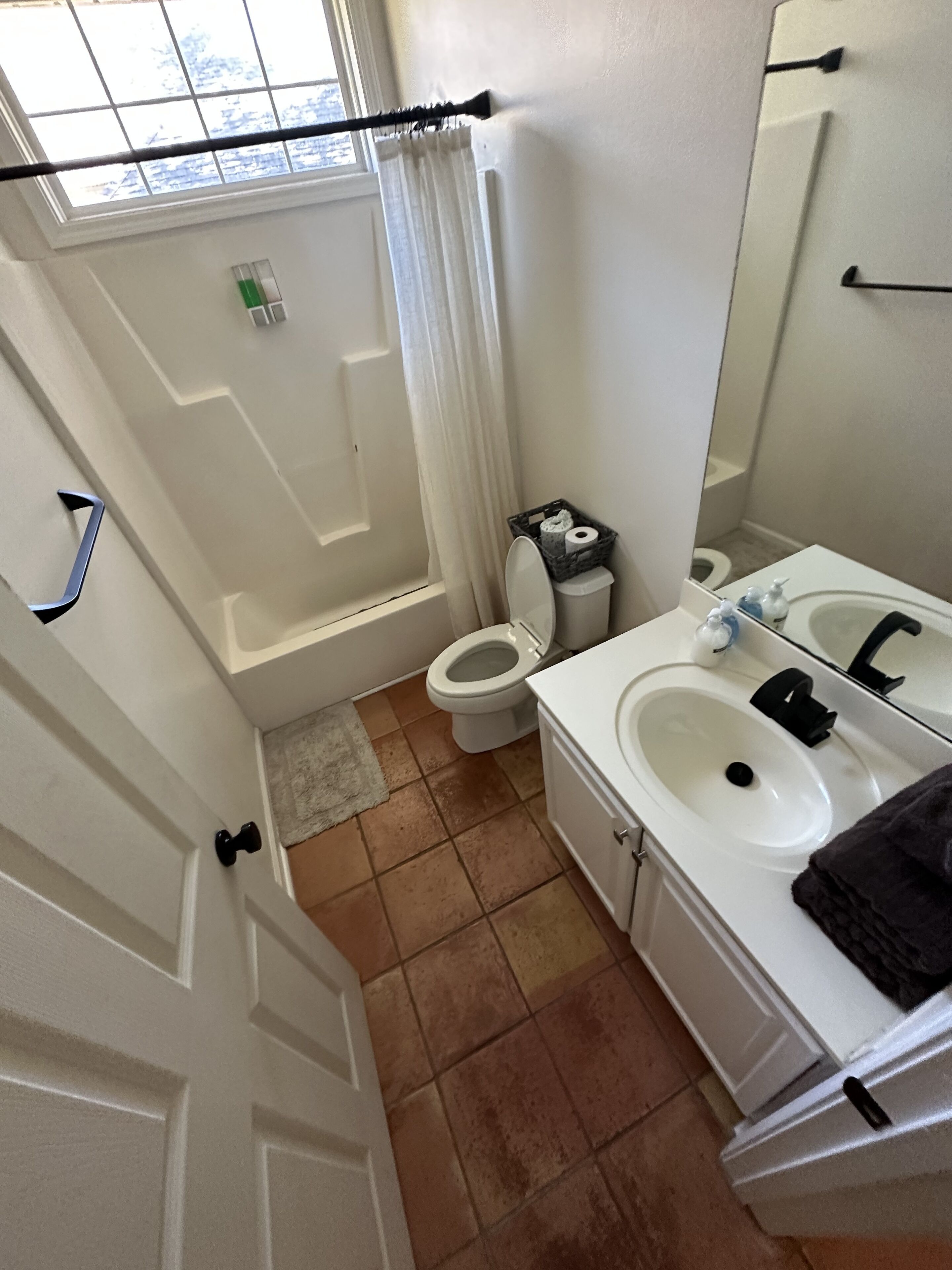 A bathroom with a bathtub, toilet, and sink.