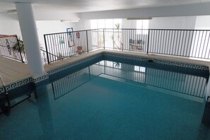 An indoor swimming pool with a tiled floor and a black metal railing. - Frigiliana 3-Bed Apartment- Sleeps 8 (Frigiliana)