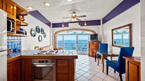 Enjoy a meal in the kitchen with an oven and dining area featuring a table and chairs.
