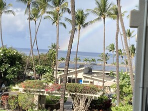 Enjoy breathtaking ocean views from this resort, surrounded by tall palm trees and a picturesque sky.