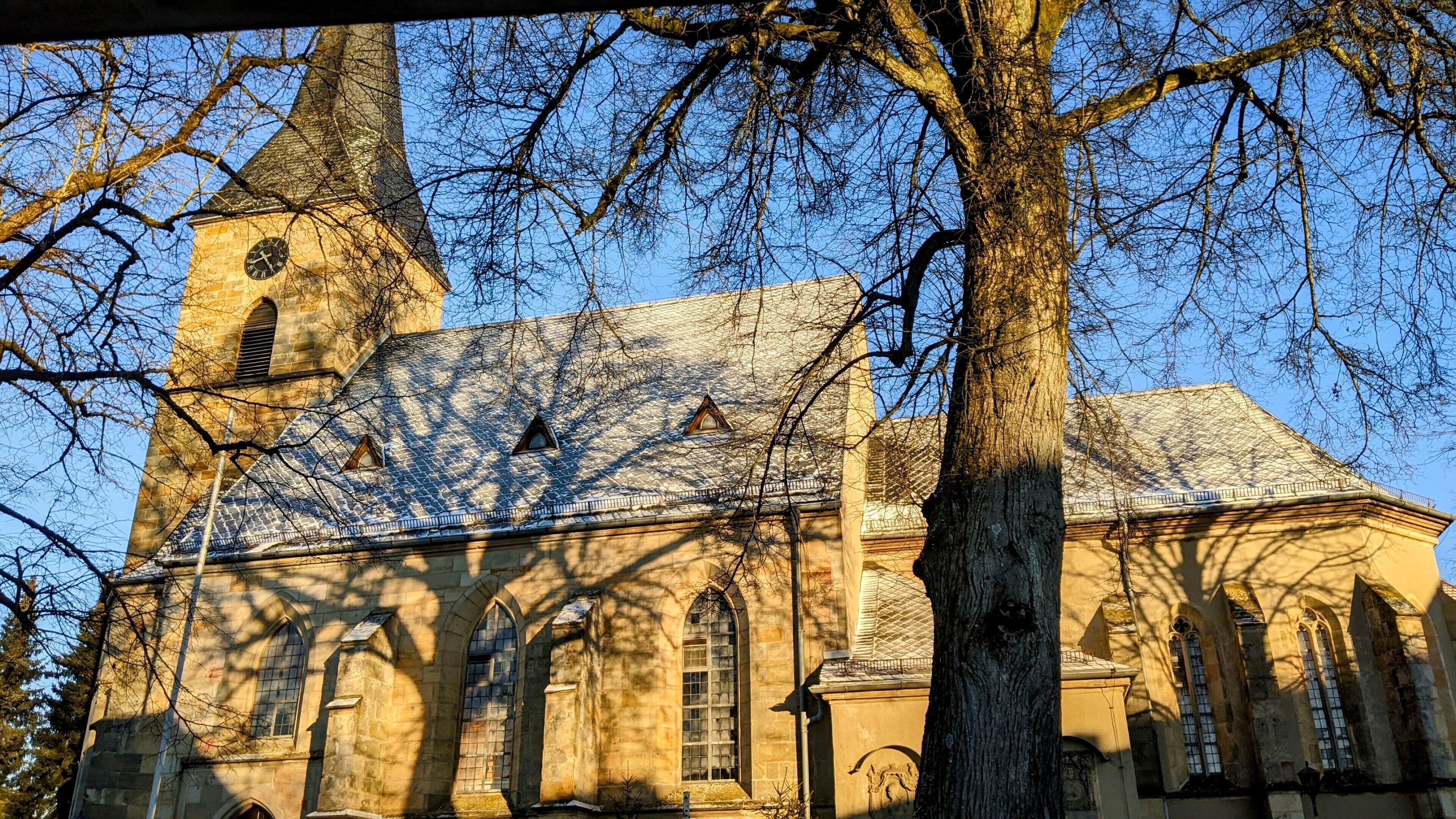 A church with a prominent tower and arched windows.