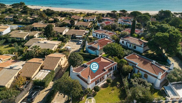 An aerial view of a coastal residential area with houses, a beach, and the ocean. - Palm Villa - Seaside Vacation (Muravera)