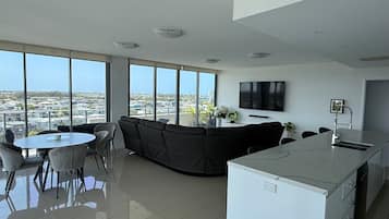 Deluxe Apartment, 3 Bedrooms | Living area | 55-inch LCD TV with cable channels, TV