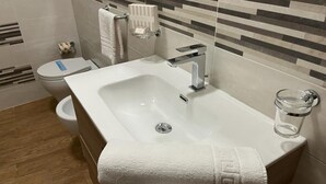 A modern bathroom with a white sink, a glass jar, and a towel on the counter. - A1 SOLE - APARTMENT WITH 6 BEDS (Balestrate)