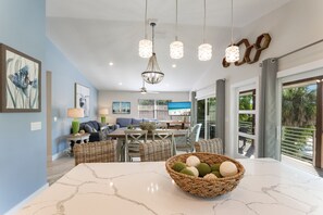 Relax in this spacious living area with a central island, dining table, and comfortable seating.