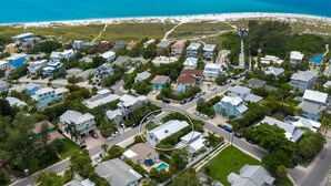 An aerial view of a coastal residential area with houses, roads, and a beach. - Meant to Be:1 Block to Beach! North End! Pool & Spa,Loaded Game Room by Anna Maria Life (Anna Maria)