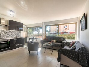 A modern apartment with a kitchen, dining area, and living room. - Le Méditerranée by Interhome (Fréjus)