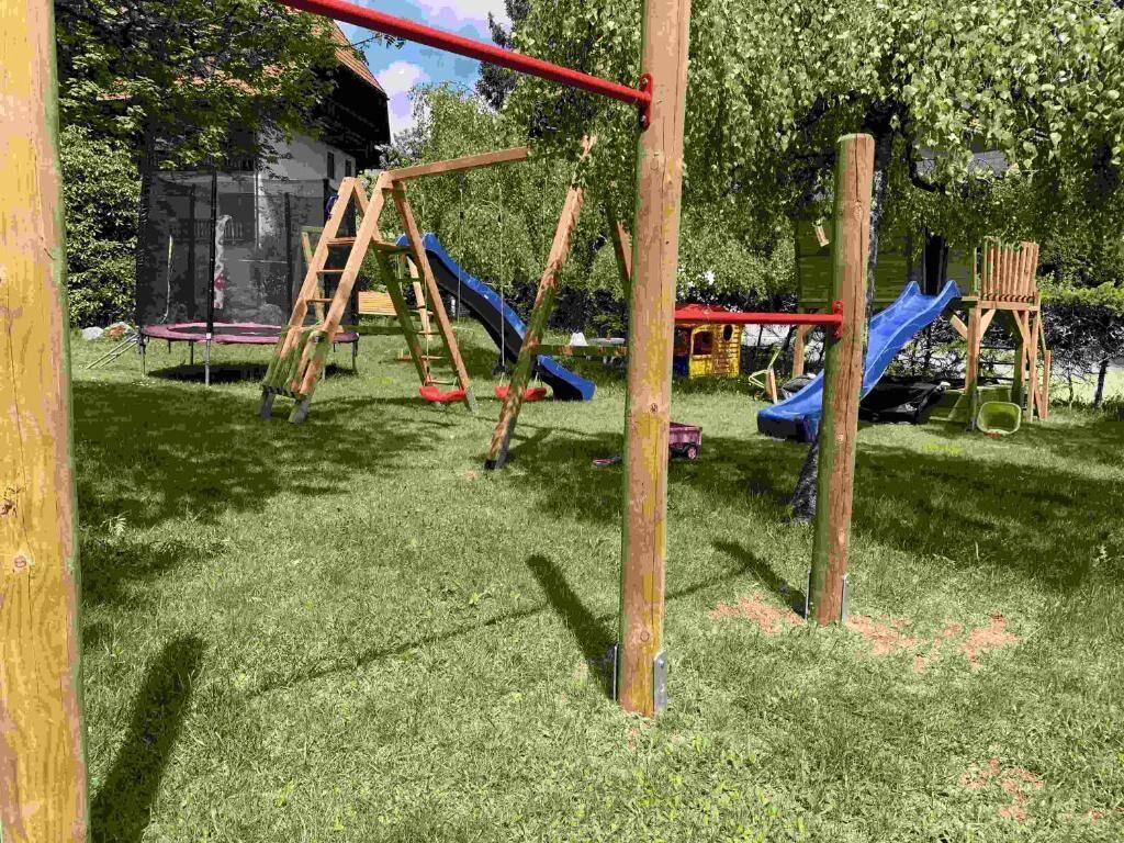 A playground with swings, slides, and a climbing structure.