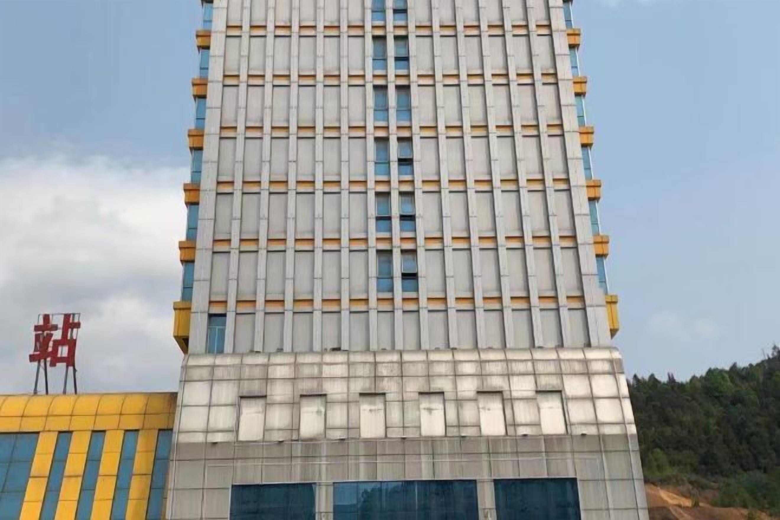 A multi-story building with a grid-like facade and a flat roof.