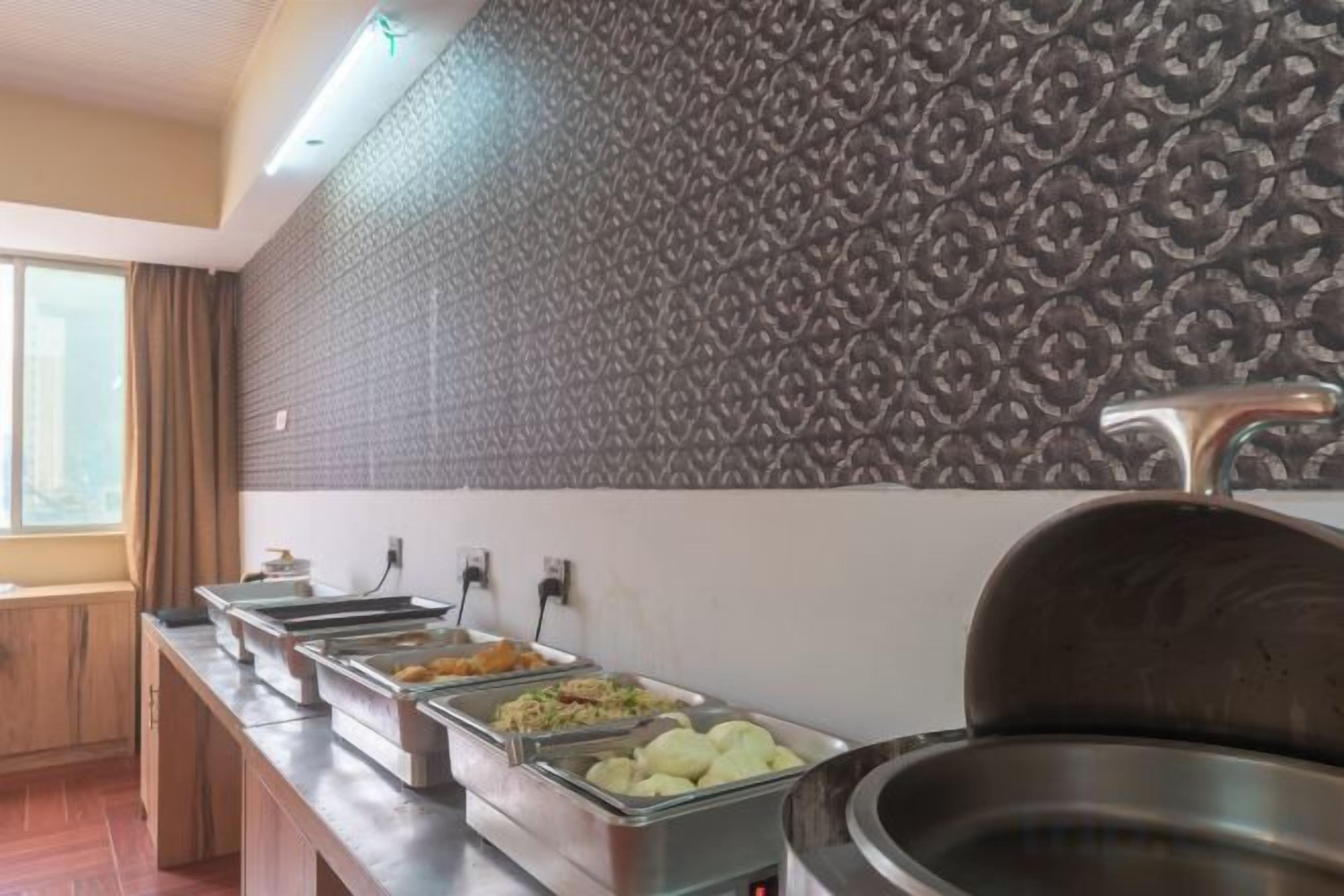 A buffet area with multiple food dispensers and a large serving pot.