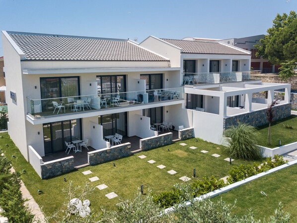 Relax in a spacious outdoor area with tables, chairs, and multiple balconies offering ample space for relaxation and entertainment.