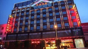 A multi-story hotel with a prominent sign at the top.