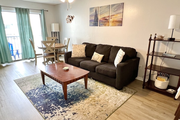 Comfortable, bright living area with cozy seating and TV