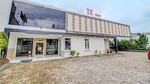A hotel with a modern facade, large windows, and a sign reading "TE Hotel". - Collection O 92242 Hotel Tanjung Emas (Purwokerto)