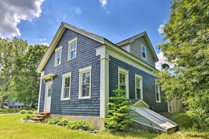 A two-story house with a front porch, a small ramp, and a satellite dish. - The Maine Retreat! Pet Friendly! (Milbridge)