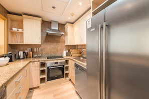 Enjoy cooking in this well-equipped kitchen with a refrigerator, oven, and dishwasher.