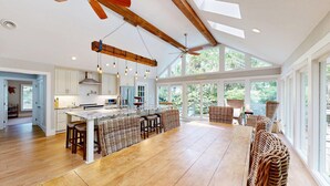 A spacious kitchen with a large island, wooden beams, and a ceiling fan. - New to the Rental Market! (Hilton Head)
