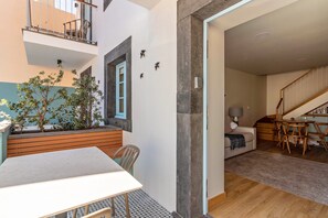 A modern interior with a dining area, a staircase, and a living space.