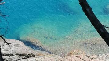 Un littoral rocheux bordé d’une eau d’un bleu limpide.