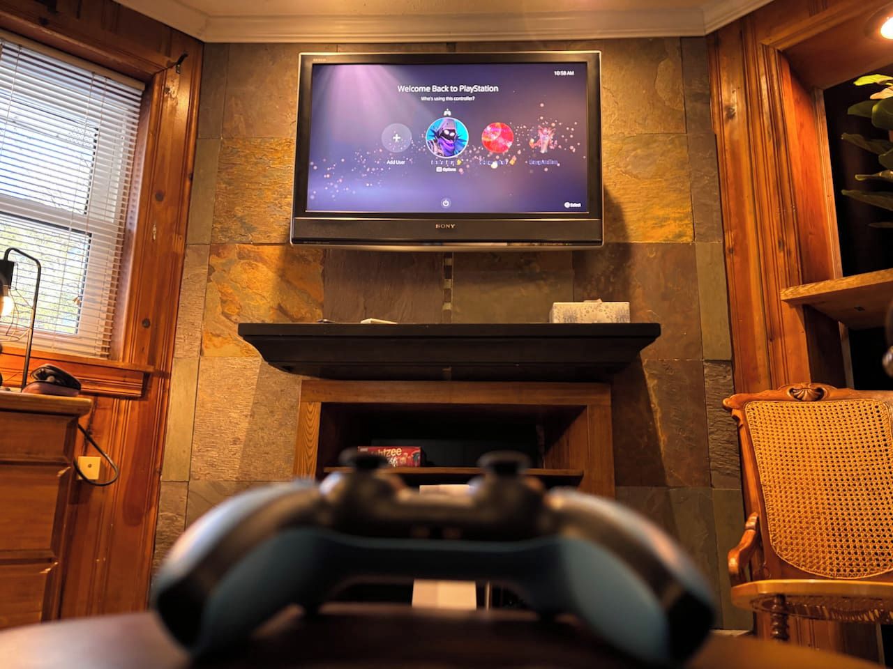 A PlayStation console in front of a television displaying a game menu.
