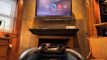 A PlayStation console in front of a television displaying a game menu.