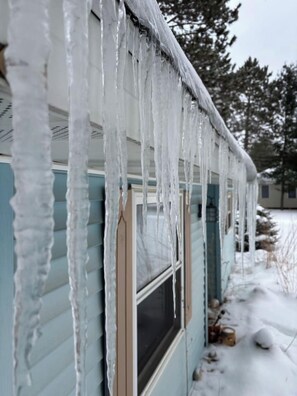 A house with icicles hanging from the roof.