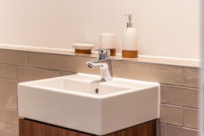 Bathtub, hair dryer, towels, soap