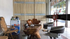 L’intérieur d’un salon avec des meubles en bois, une machine à café et un sèche-cheveux.