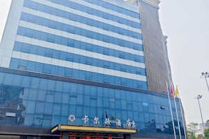 A modern building with a reflective glass facade and a prominent vertical structure.