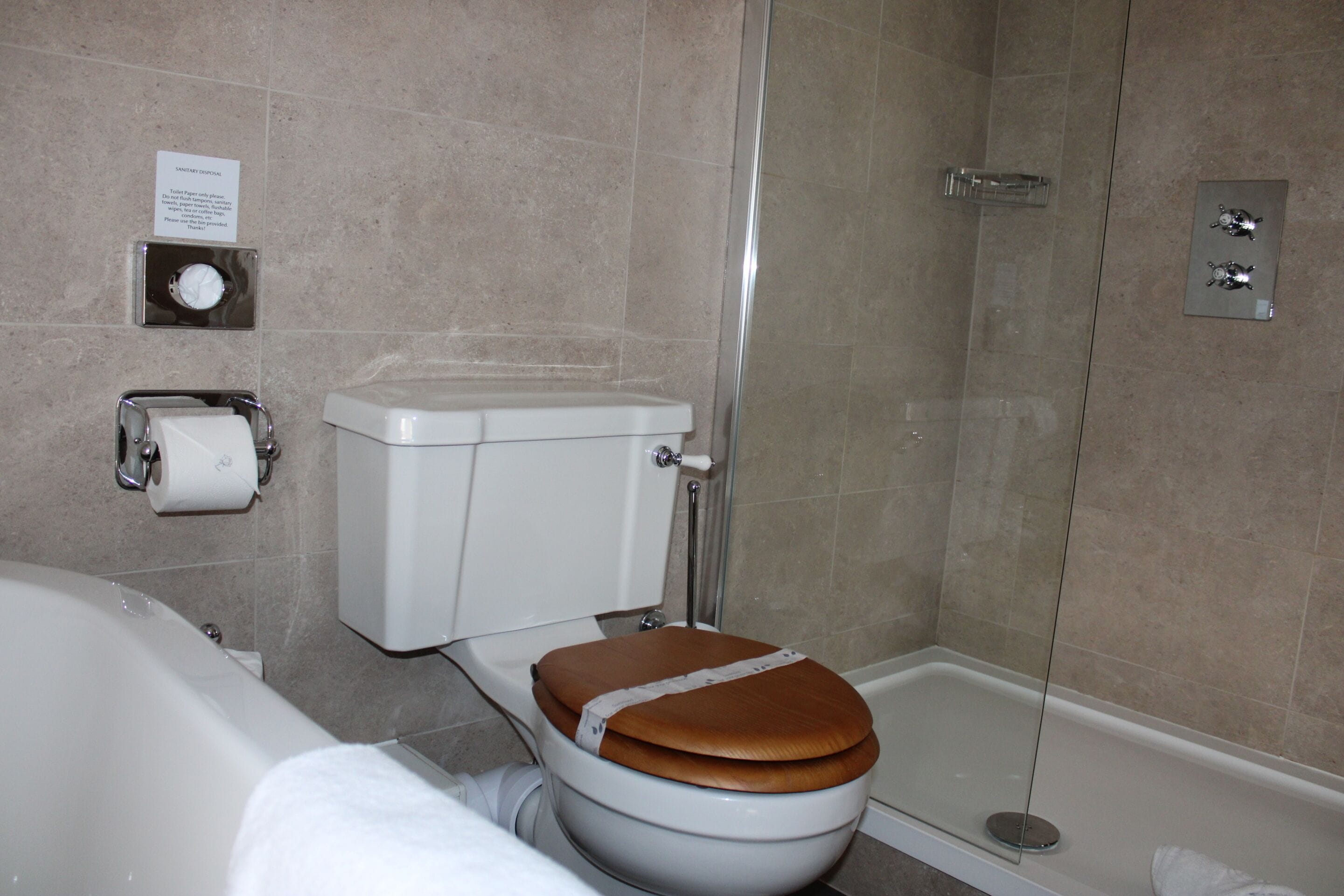 A bathroom with a toilet, a shower, and a bathtub.