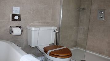 A bathroom with a toilet, a shower, and a bathtub.