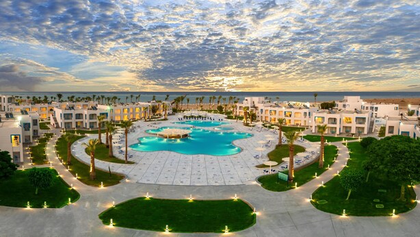 A resort with a central swimming pool, multiple guest buildings, and a beachfront view. - Casa Blue Resort (Marsa Alam)