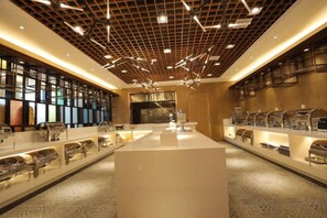A modern interior with a central island, glass display cases, and a patterned ceiling.