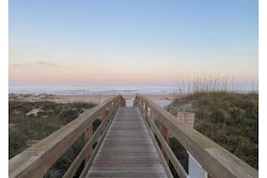 Walk along the boardwalk to the sandy beach.