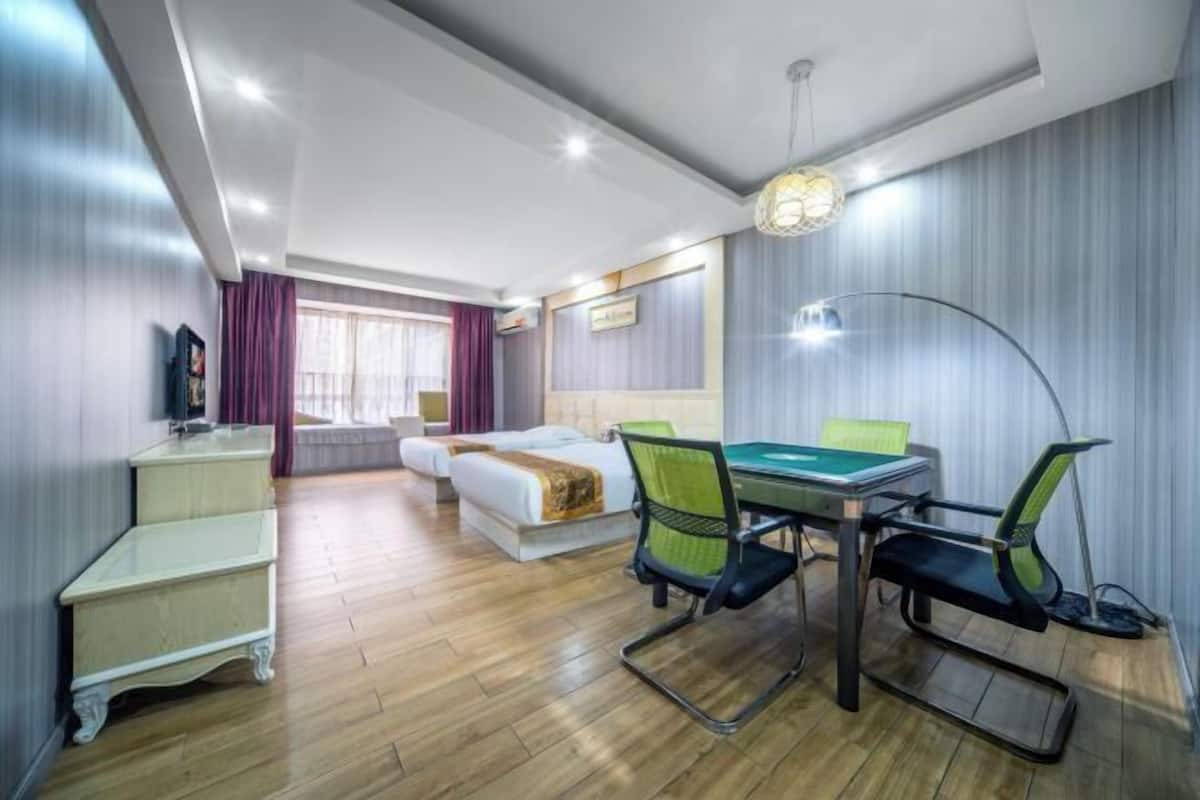 Ein Hotelzimmer mit Bett, Schreibtisch, Stühlen und einem Billardtisch.