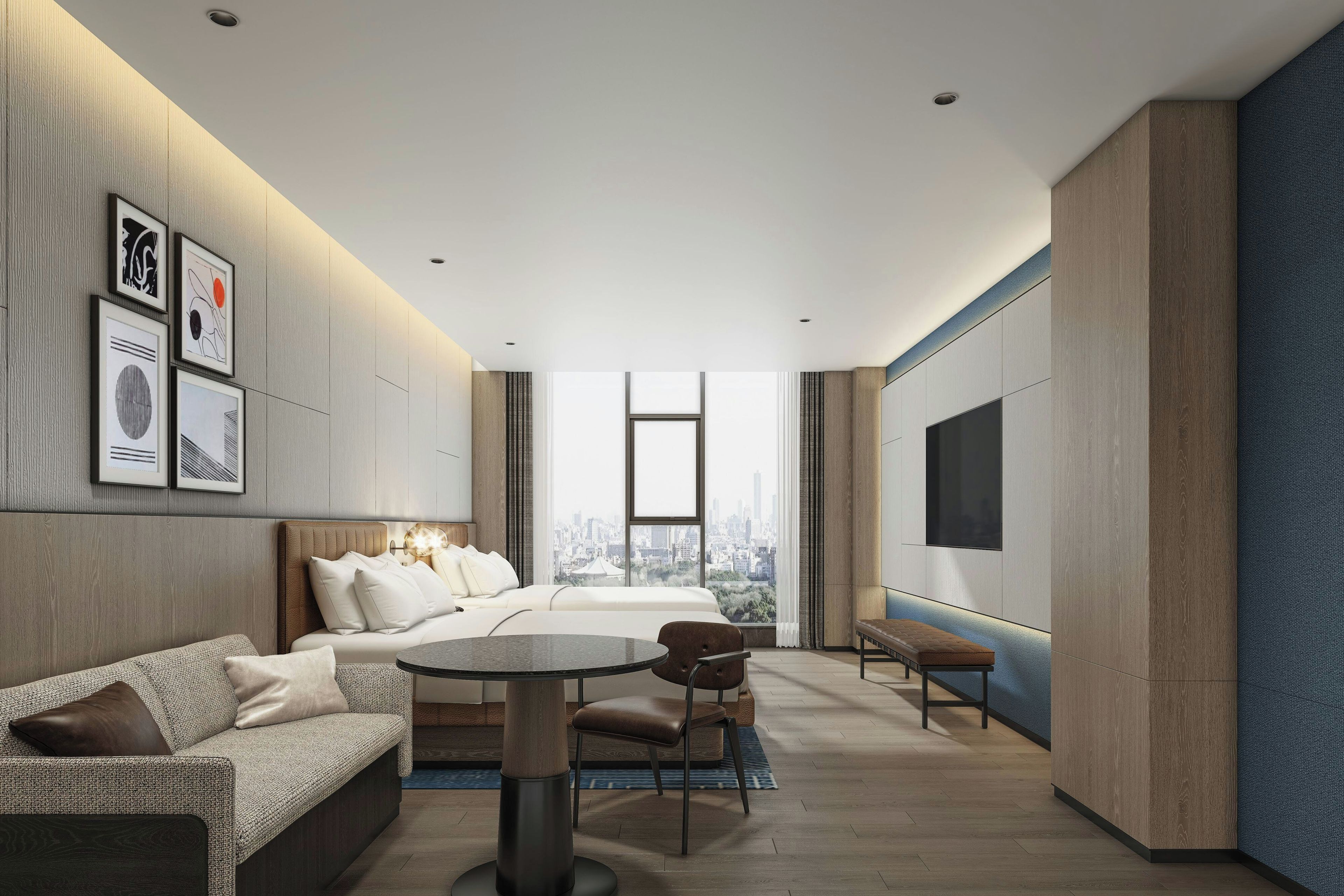 A modern hotel room with a bed, sofa, dining table, and chairs.