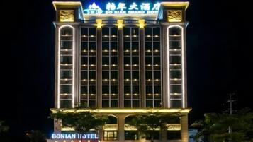 A multi-story hotel with illuminated signage and a prominent entrance.