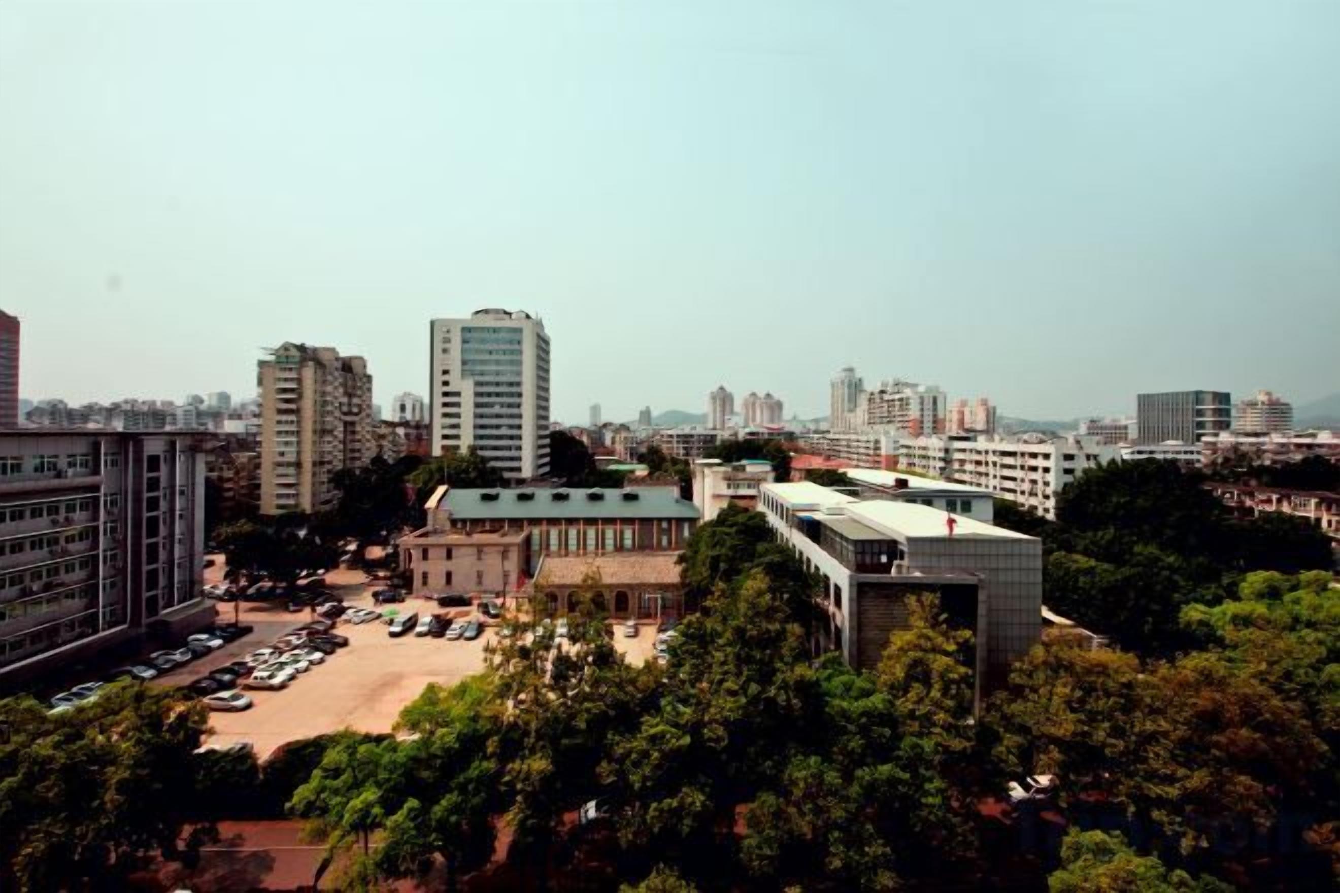 A cityscape with various buildings, including a prominent high-rise and several mid-rise structures.