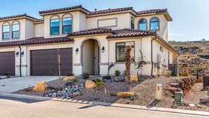 A two-story house with a garage, large windows, and a landscaped front yard with rocks and plants. - Splash Pad: Pickleball, E-bike, Scooters, Bicycles (Washington)