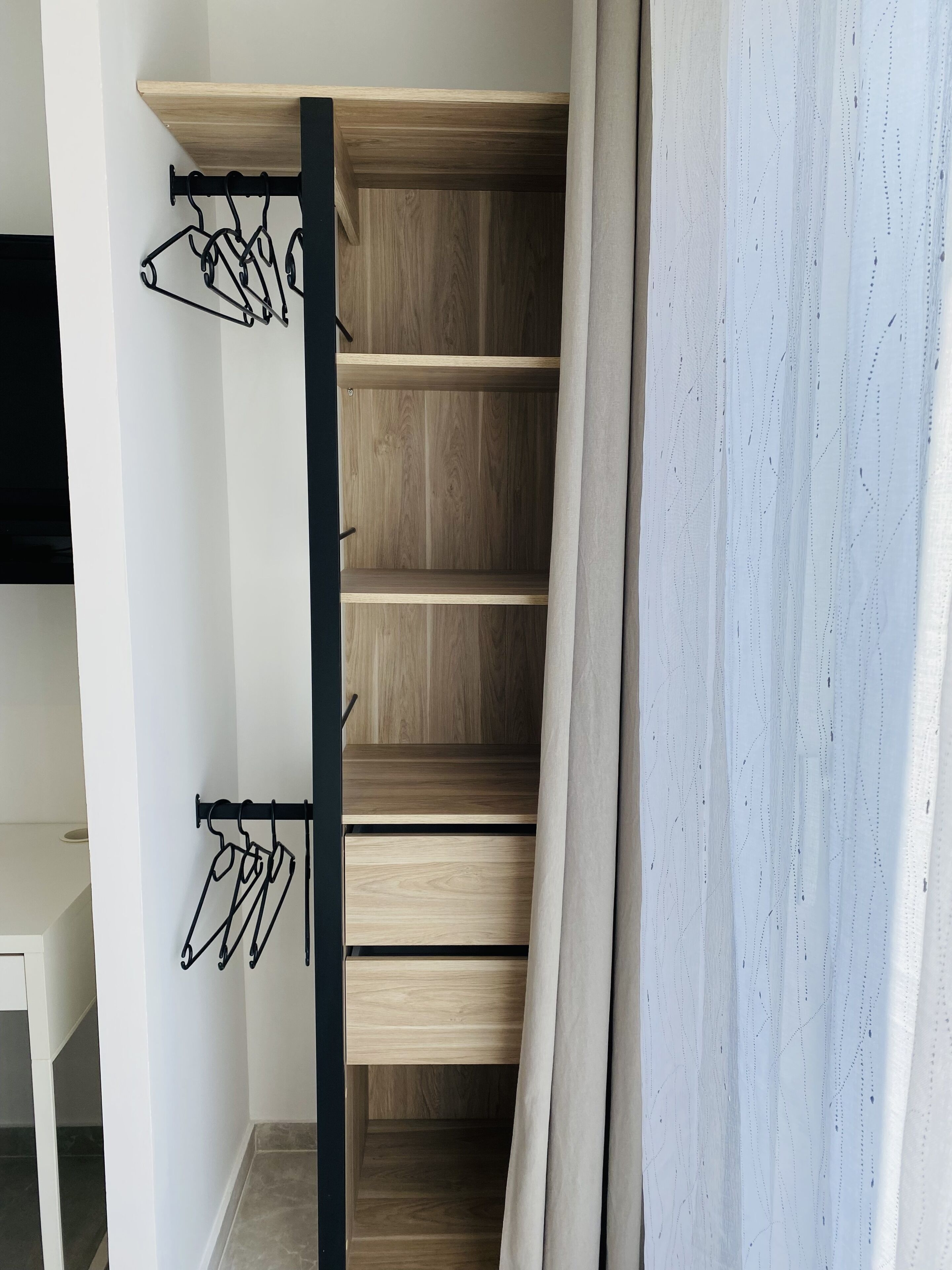 Un escalier avec des marches en bois et des crochets en métal pour suspendre des objets.