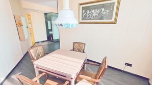 A dining area with a table and chairs, a pendant light, and a framed picture on the wall. - Shankee Hotel (Danyang Railway Station Glasses City) (Danyang)