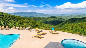 A pool area with lounge chairs and a view of a mountainous landscape. - 2BD/Sevierville - Smoky Mountains Resort w/pools! (Sevierville)