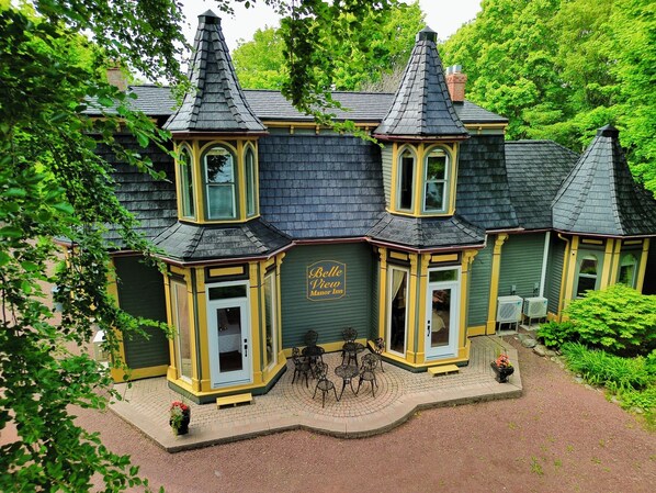 A Victorian-style building with a green facade and multiple gabled roofs.
