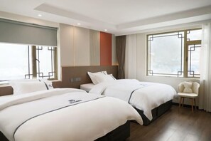 A hotel room with two beds, a chair, and large windows. - Foguang Hotel (Emeishan City)